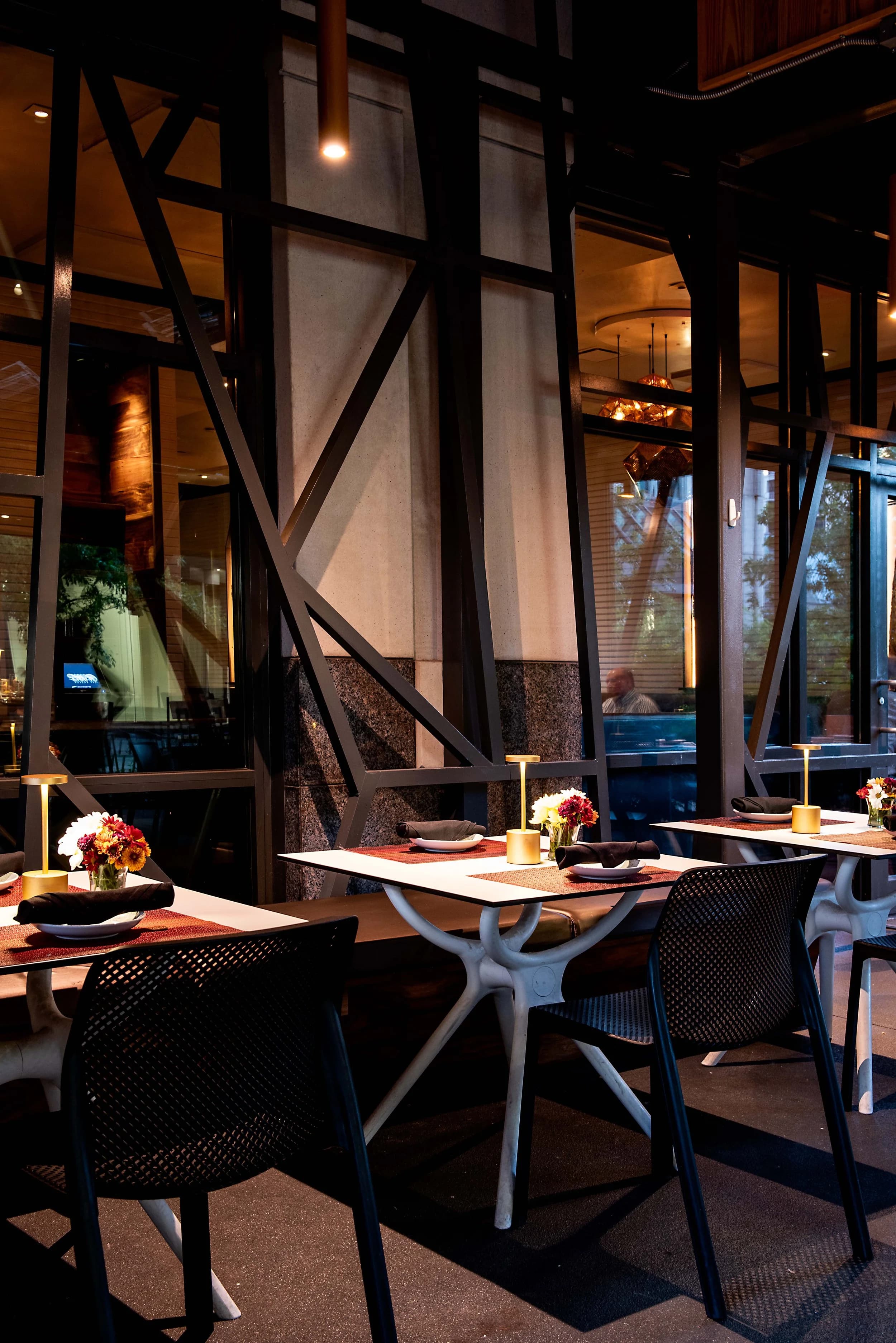 Patio tables set with flowers and table lamps at Nan Thai Buckhead